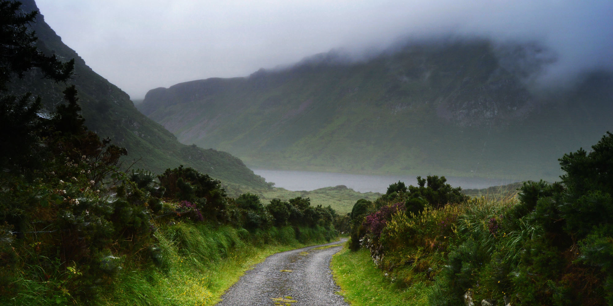 Scenic view of mist rolling in over the hills