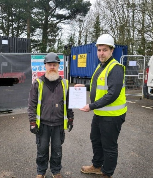 Karl Foster is presented with his 3D Employee of the Month award by Doz Berntsen